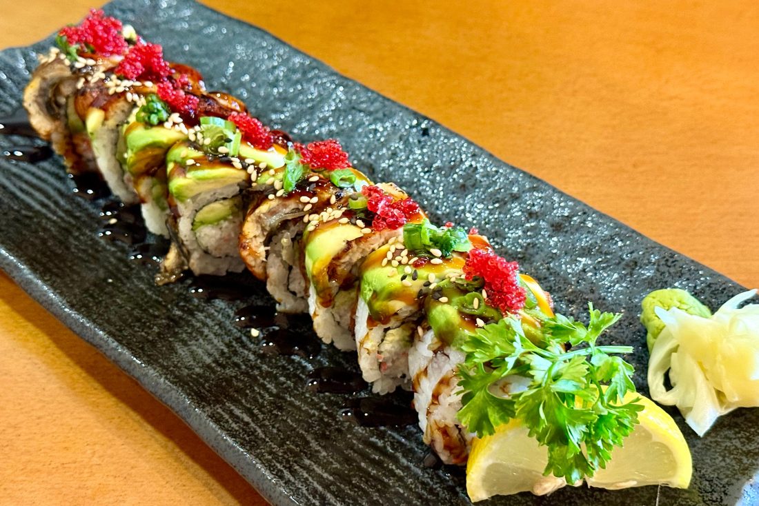 Dragon roll topped with avocado, eel and tobiko