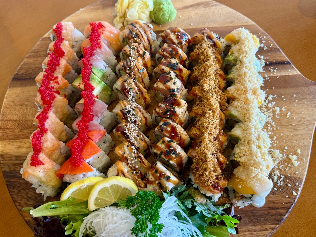 Sushi & Co Special Tray with six specialty rolls on a wooden tray